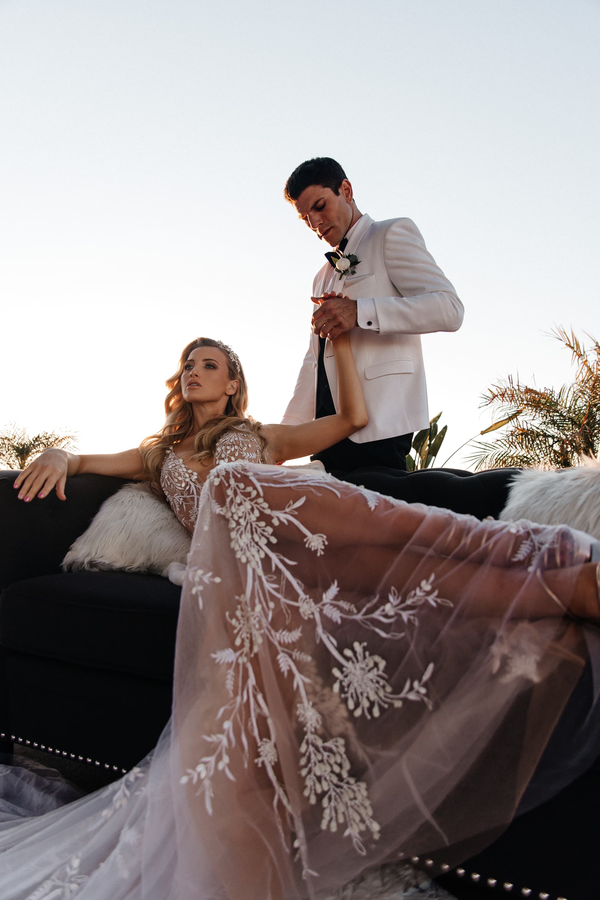 Editorial bride and groom on velvet couch