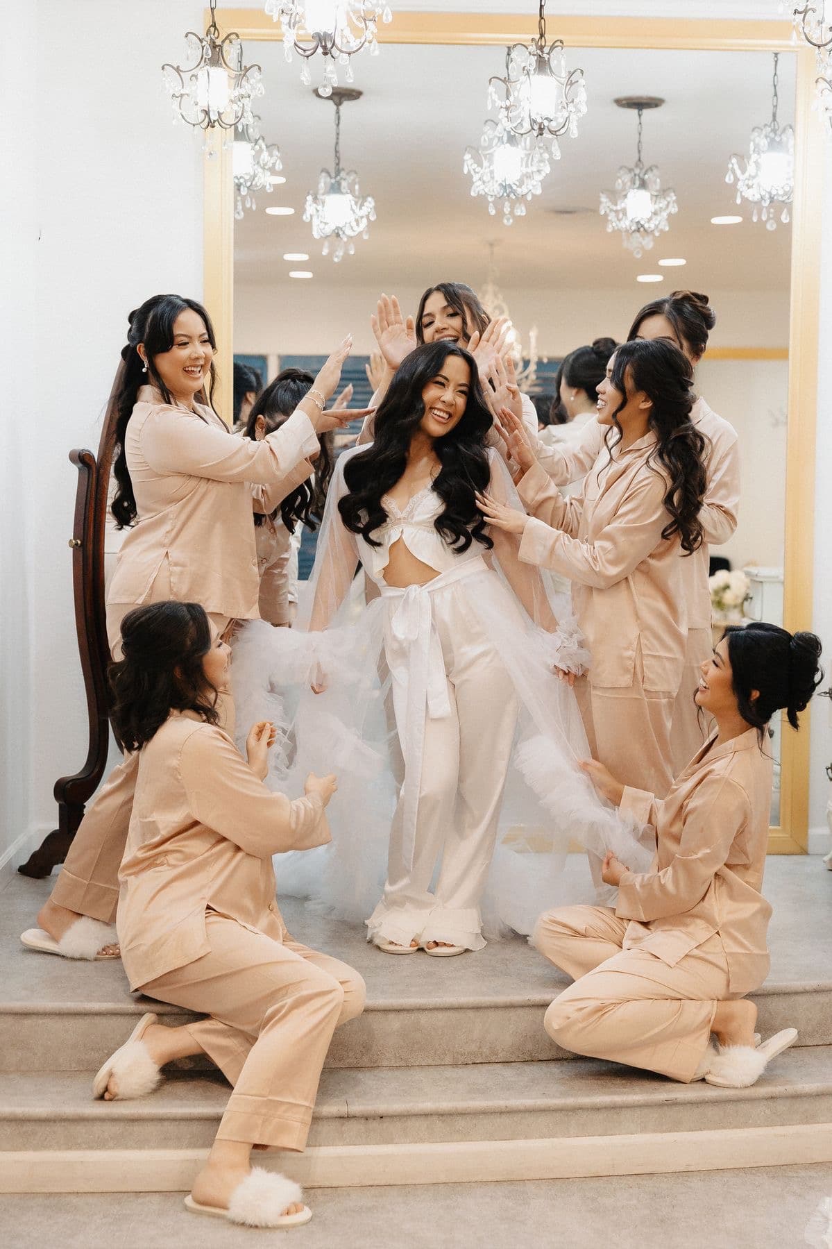 Bride with bridesmaids in champagne pajamas celebration