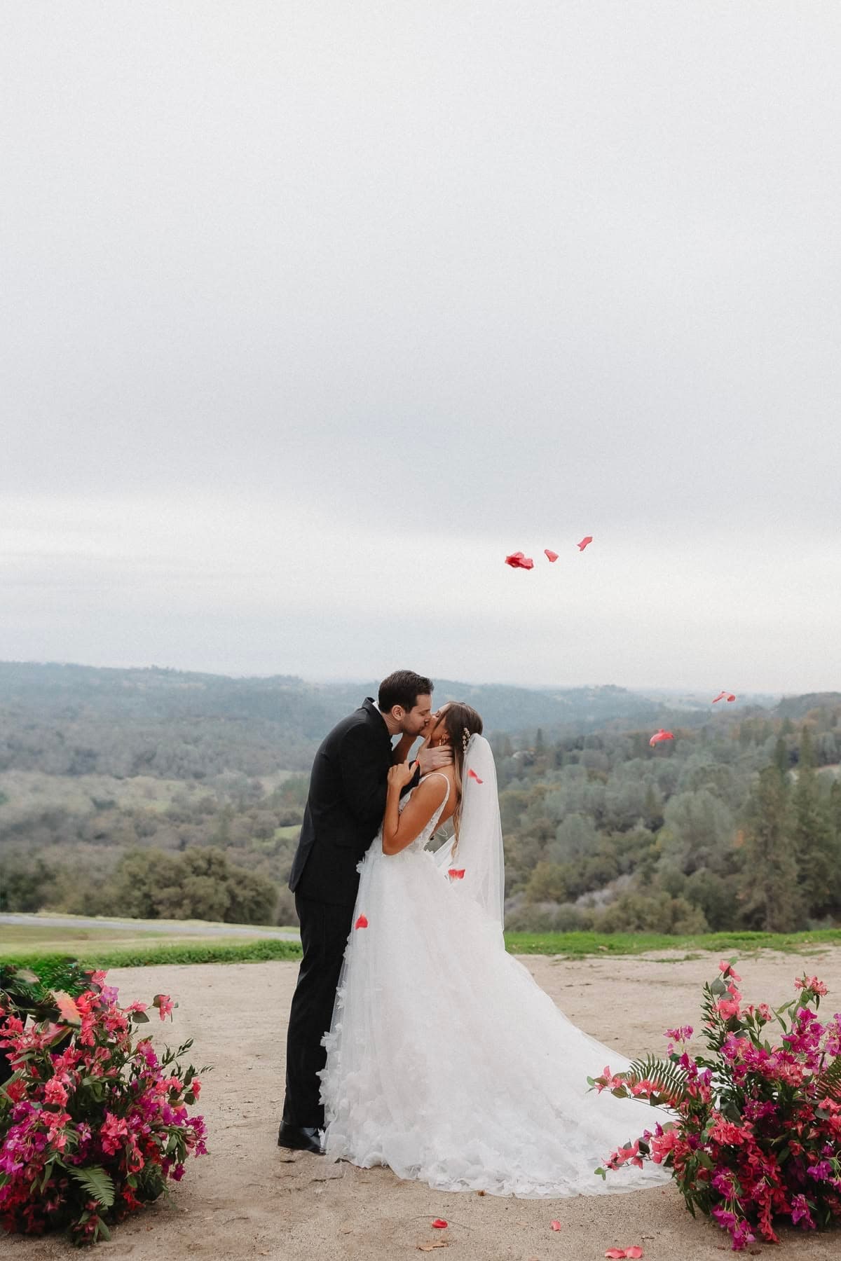 Kiss with rose petals and pink bougainvillea flowers