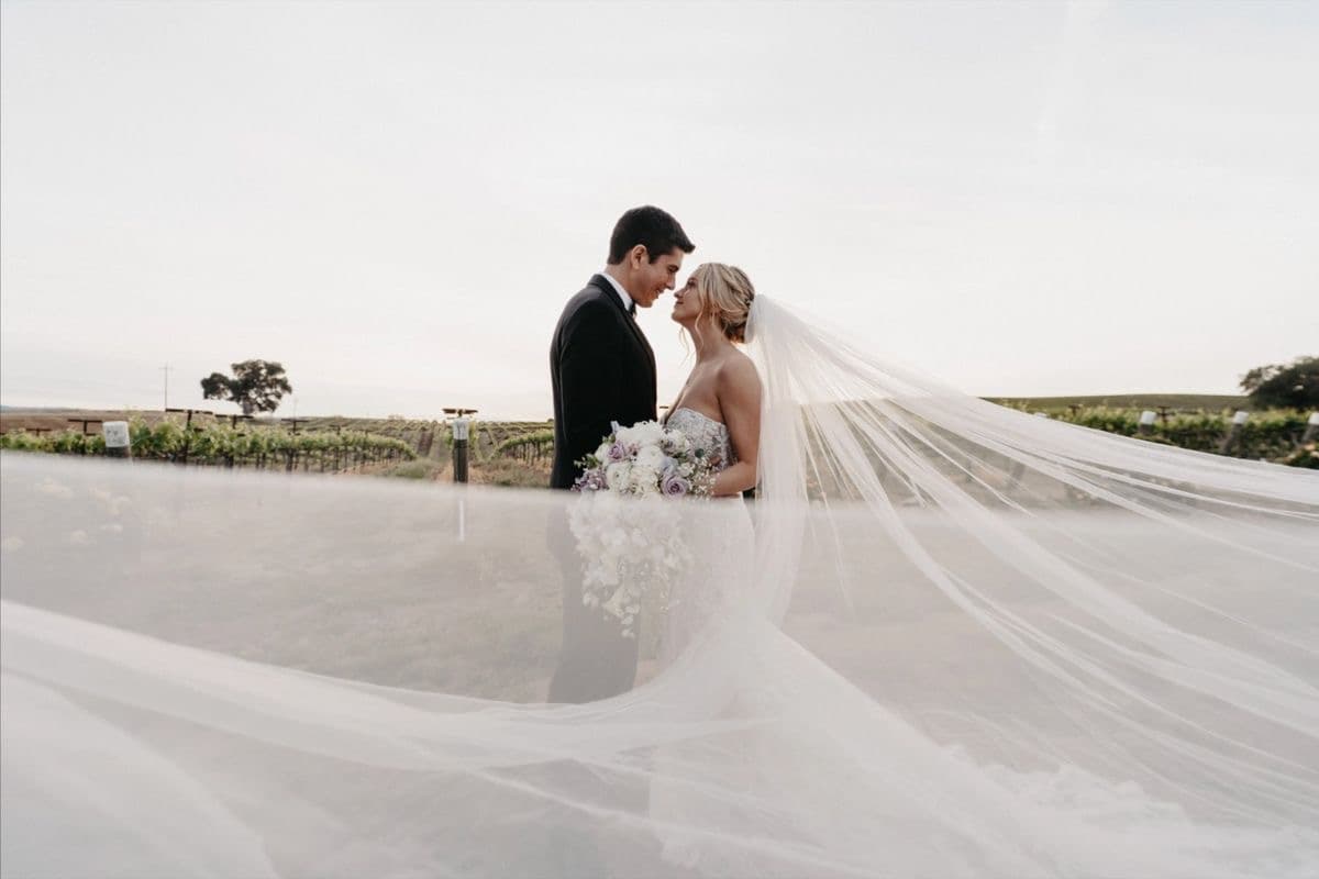Couple in vineyard with flowing veil