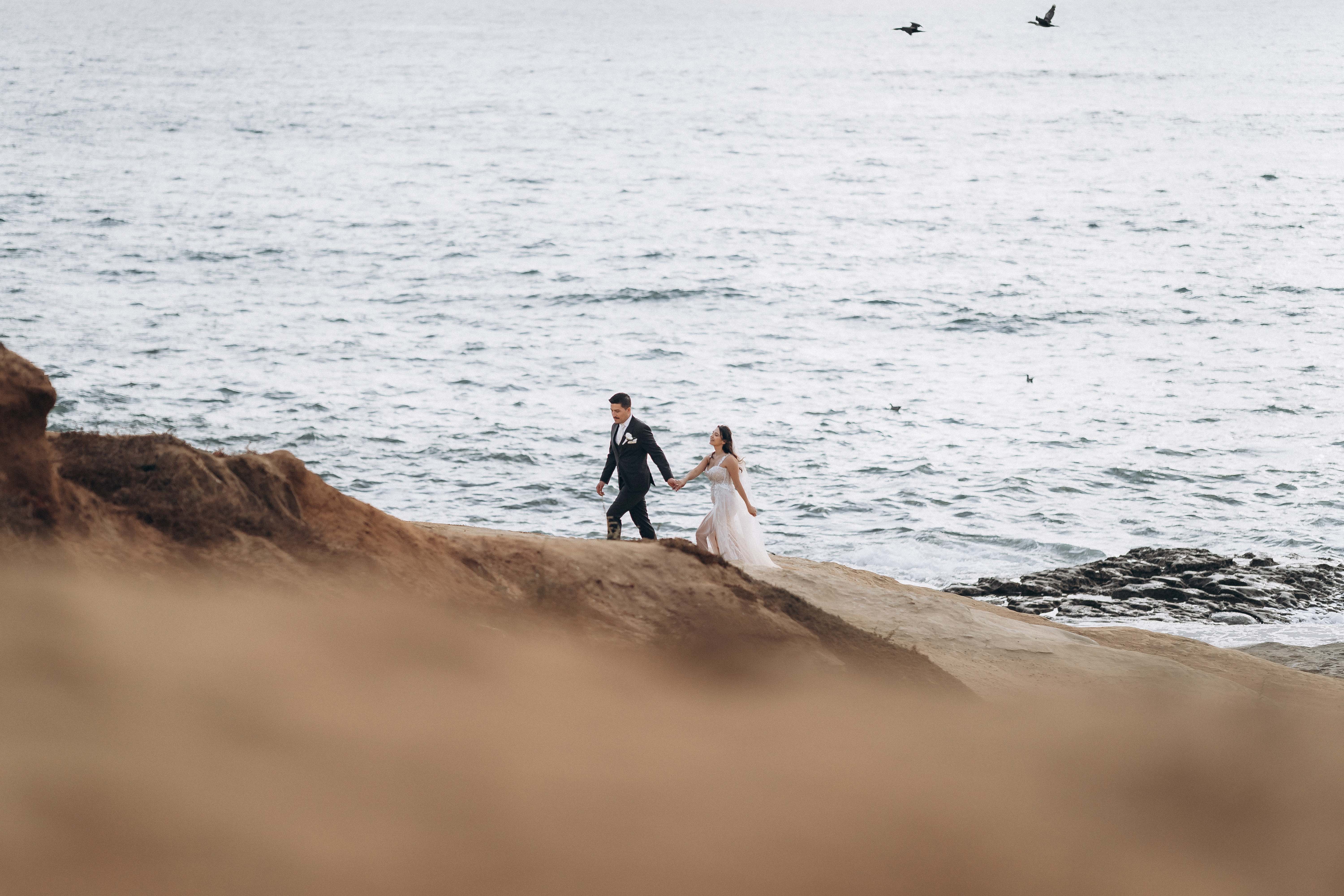 Couple walking along coastal cliffs