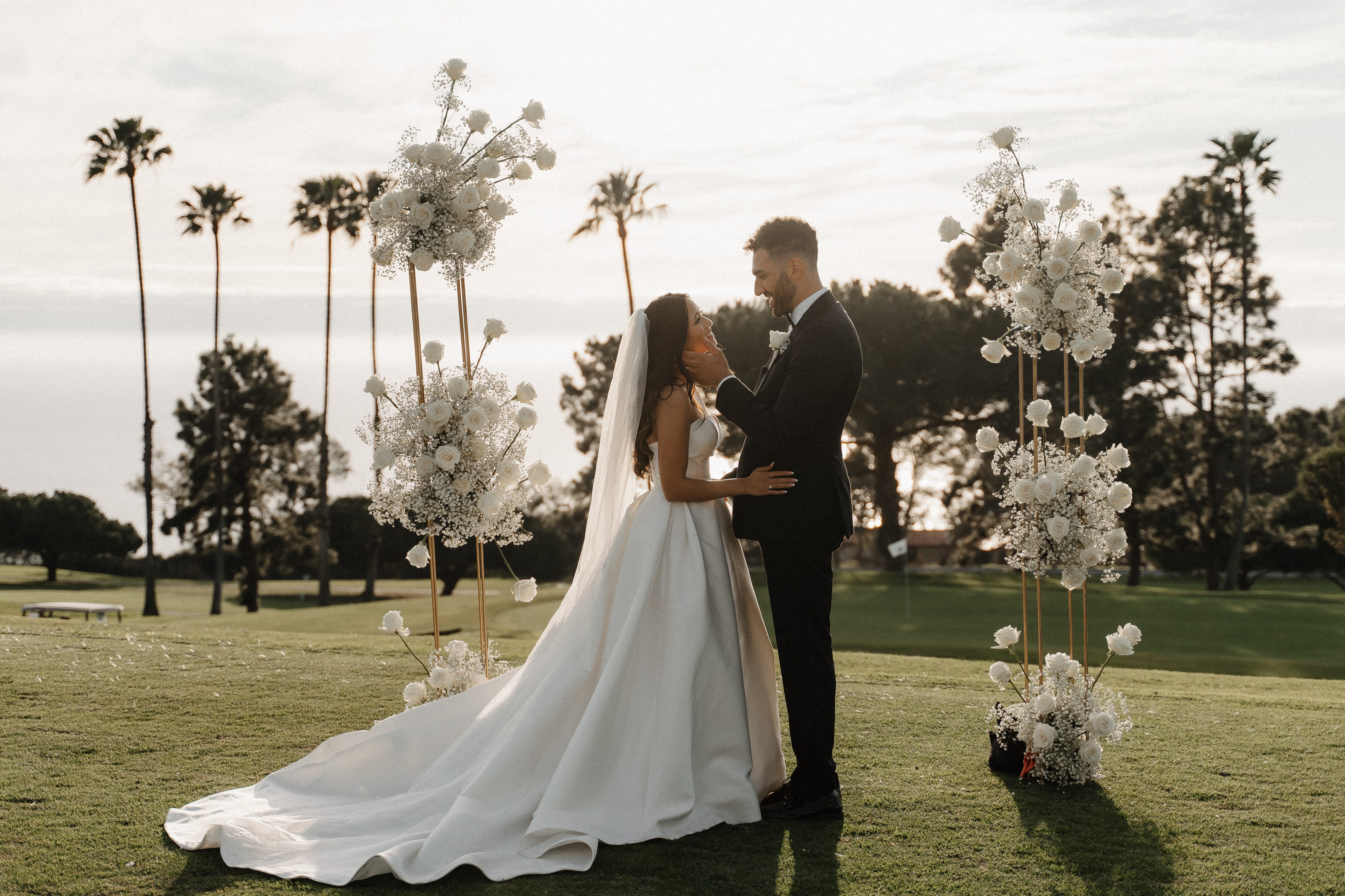 Couple at floral altar with palm trees