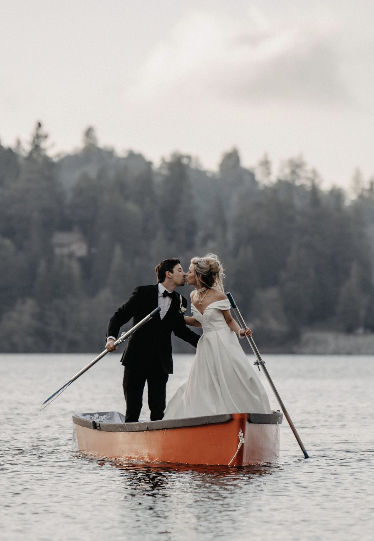 Couple kissing on a boat on the lake