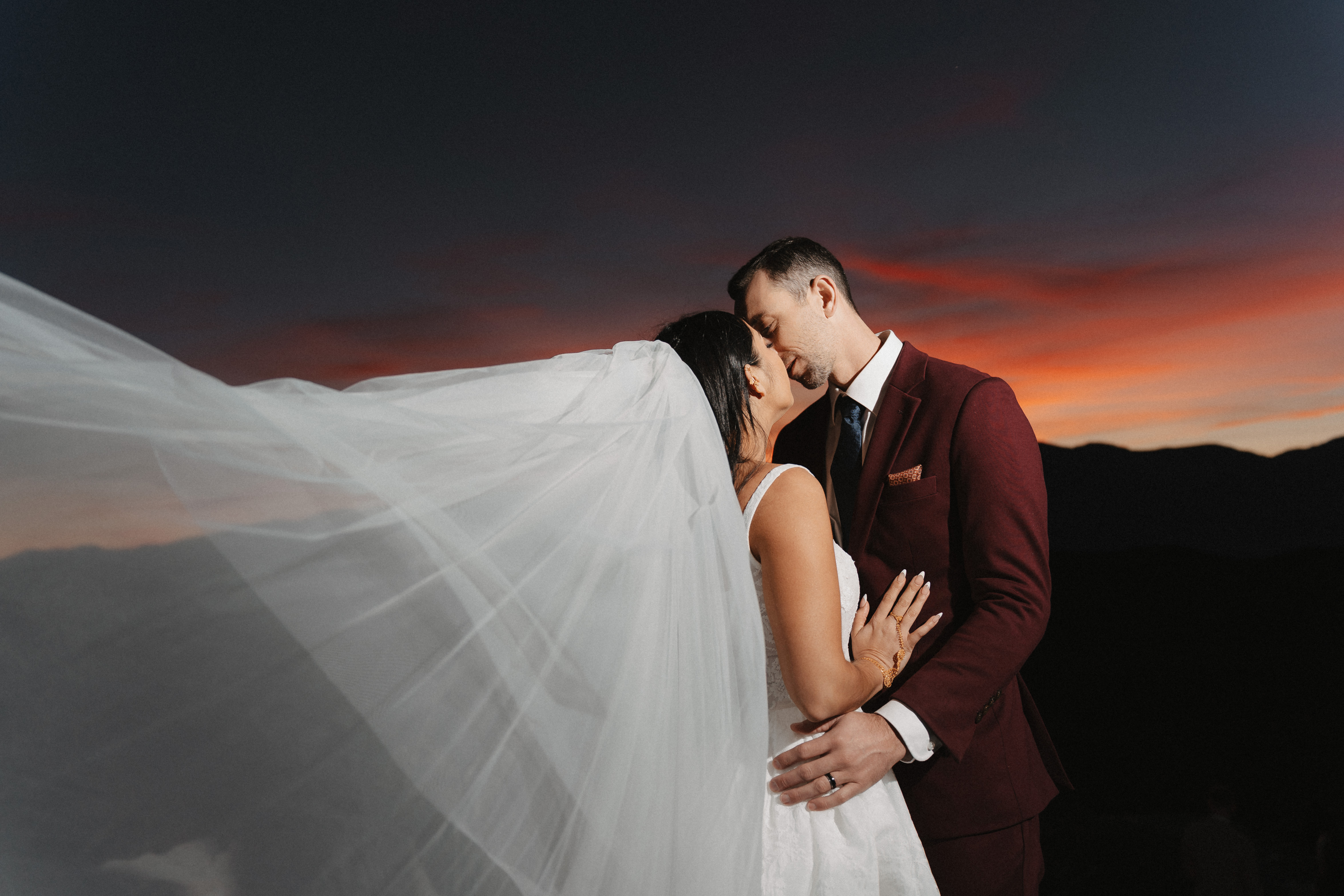 Couple embracing at dramatic sunset