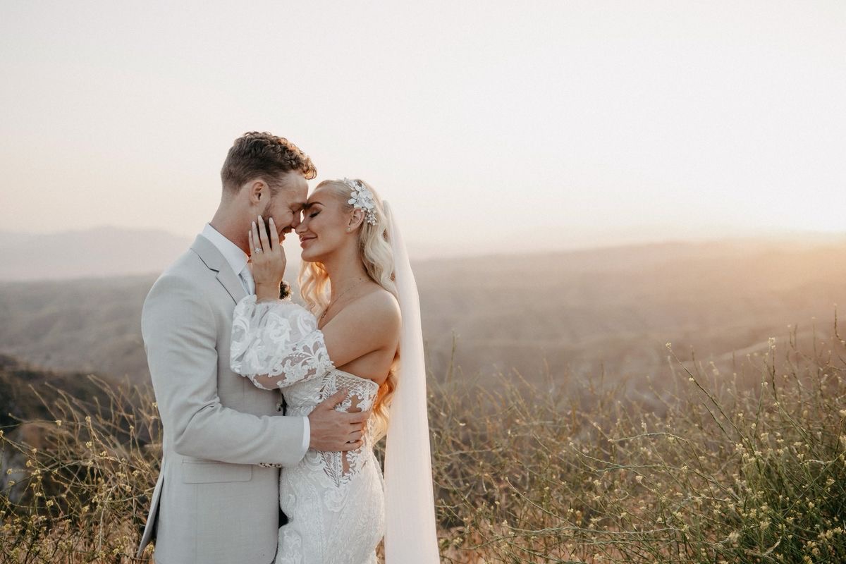 Couple intimate moment at golden hour hillside