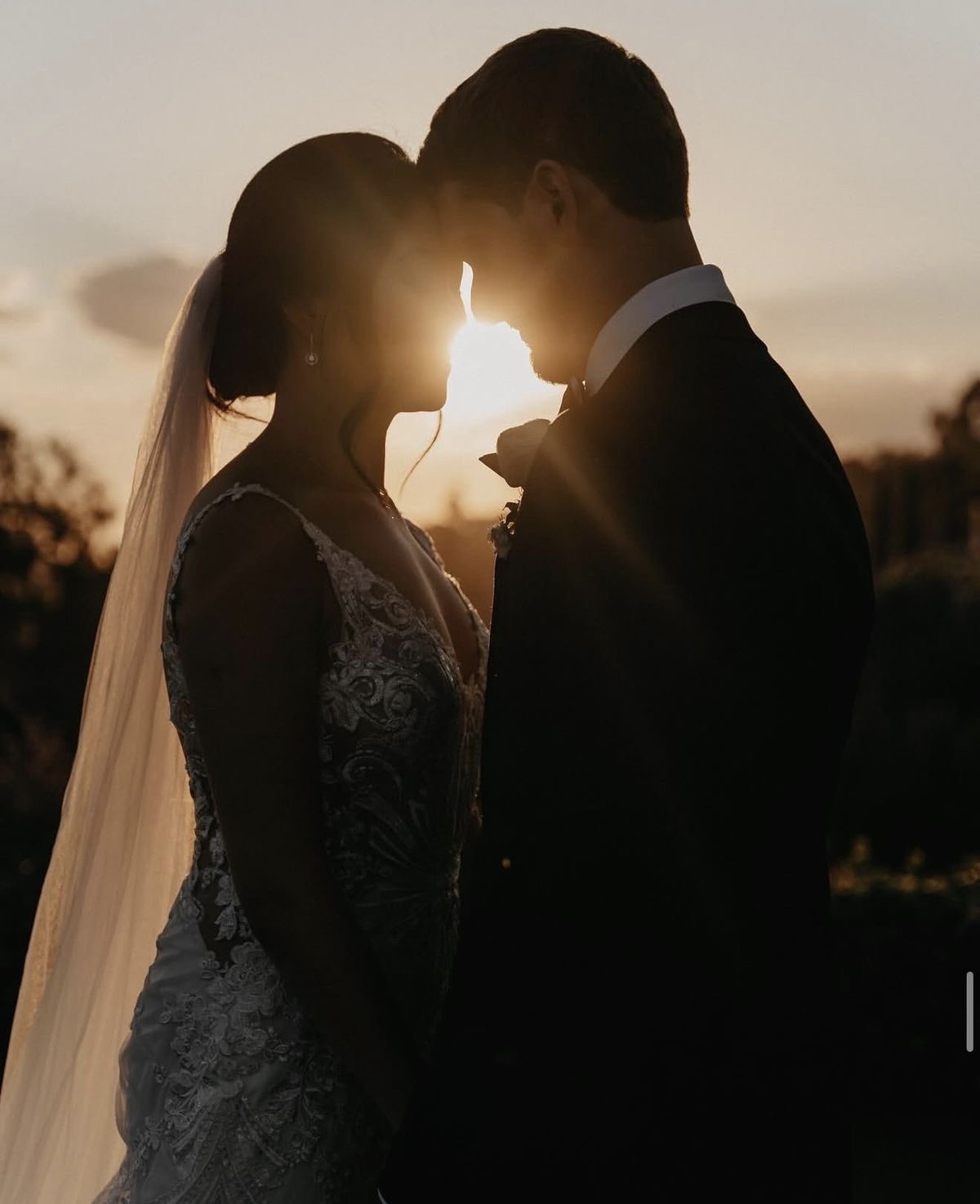 Silhouette couple with sun flare between them