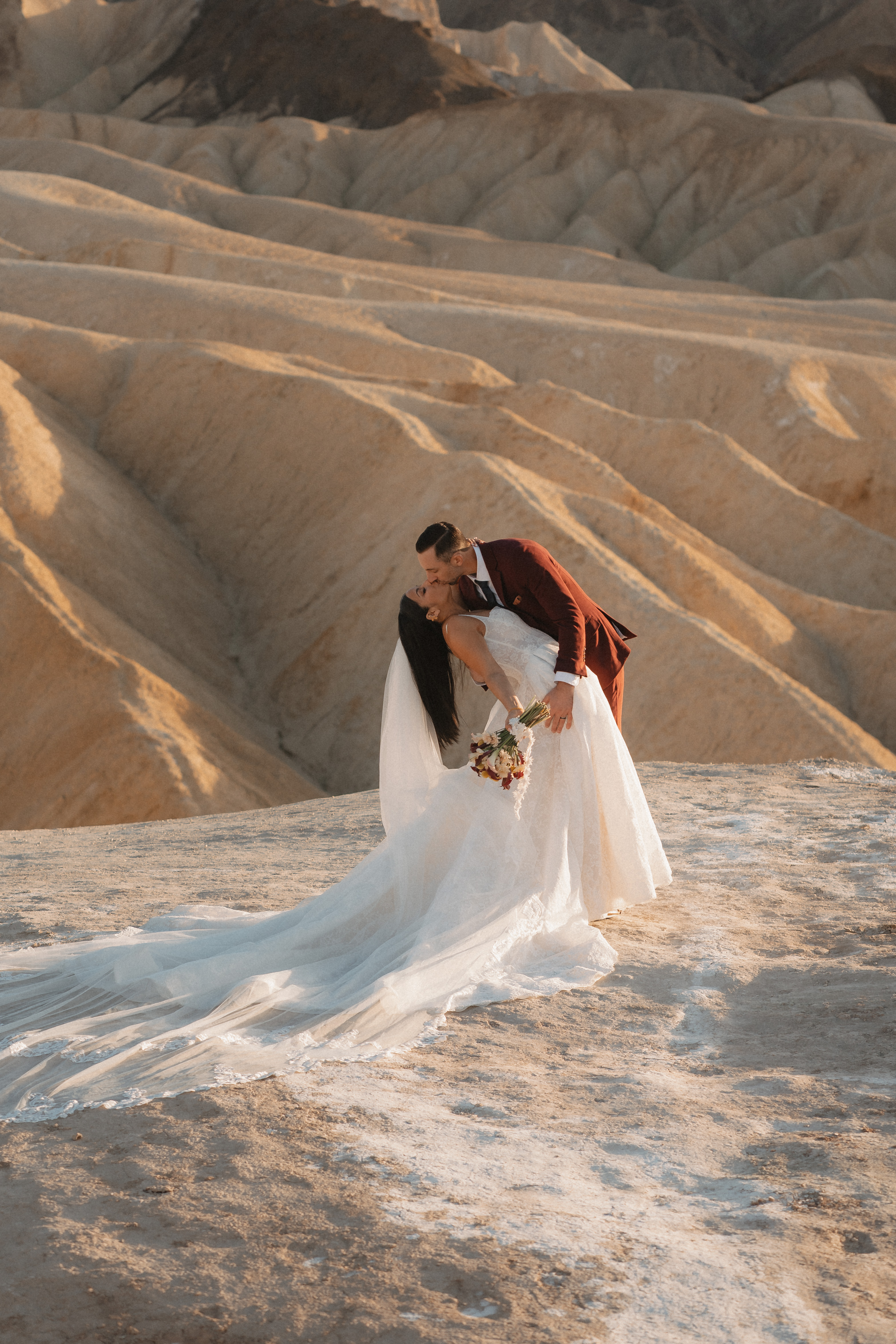 Dramatic dip kiss in Death Valley desert badlands