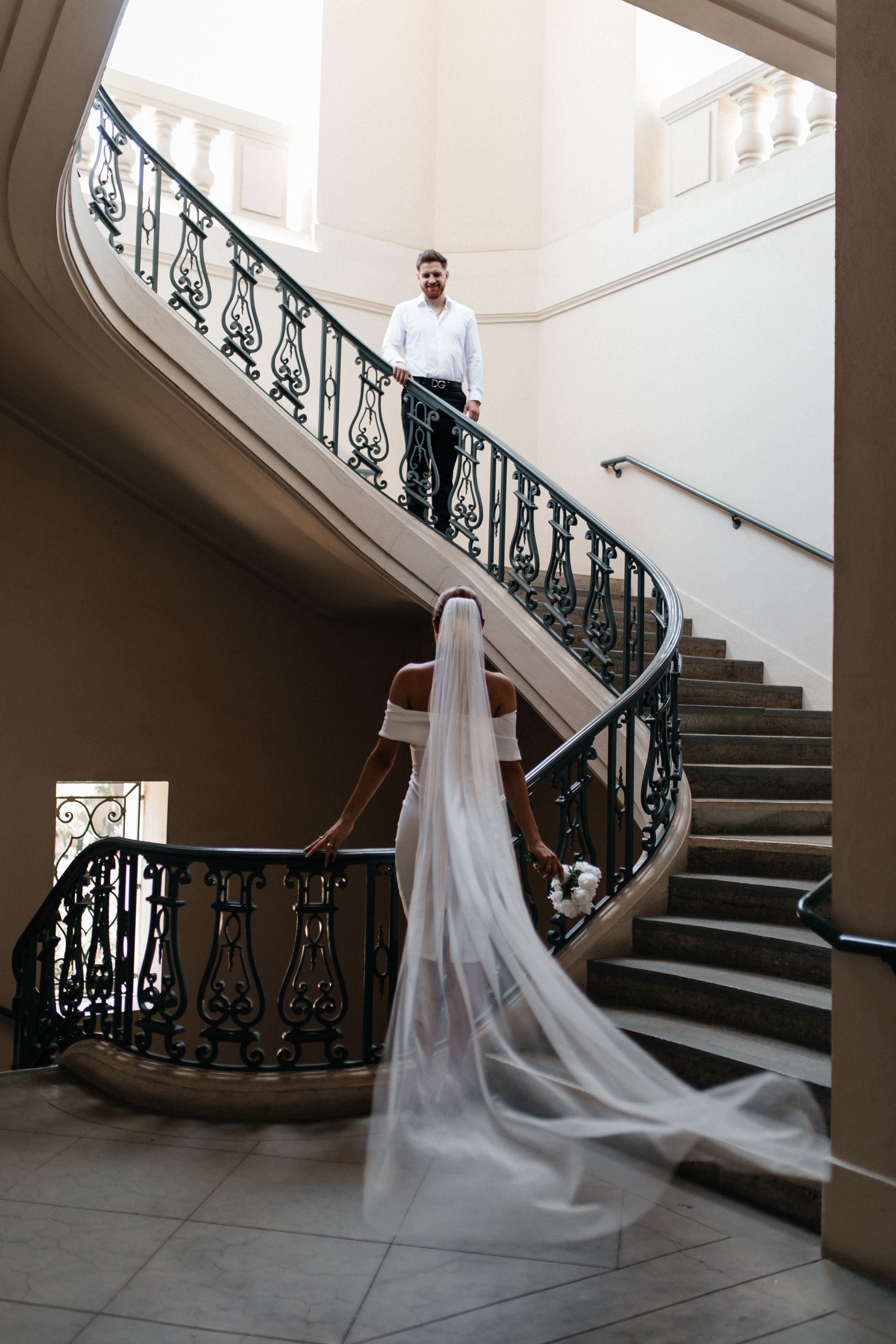 Bride on spiral staircase with groom