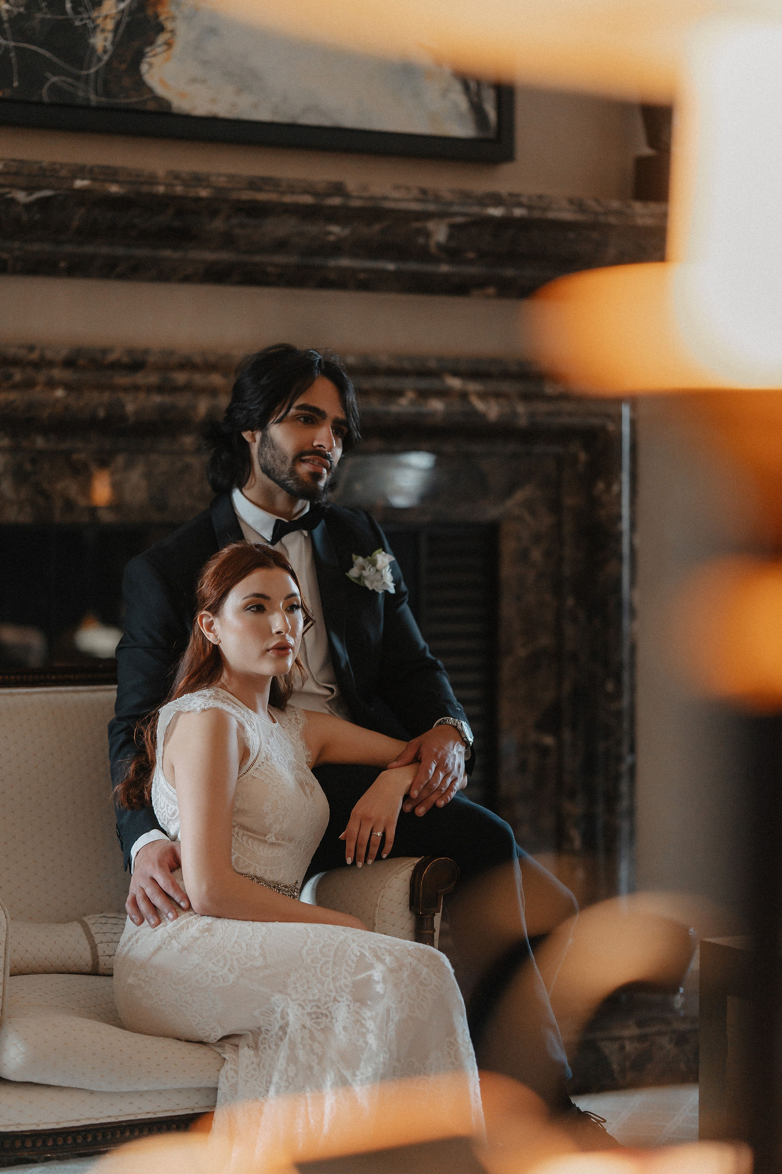 Elegant couple portrait by fireplace